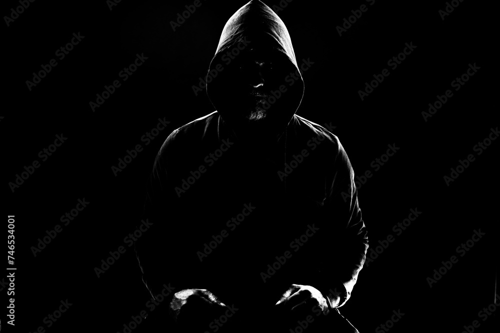 a shady figure that could represent a criminal, a hacker, ambiguity and duplicity