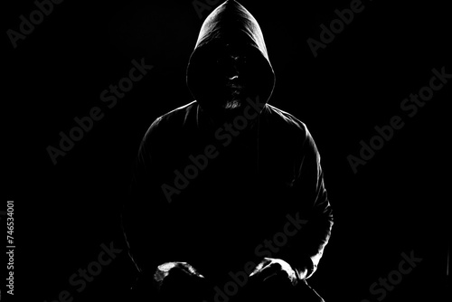 Obraz na płótnie a shady figure that could represent a criminal, a hacker, ambiguity and duplicity w salonie