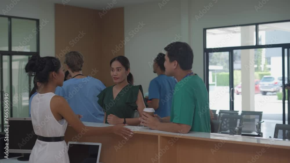 People in the lobby of the clinic waiting for a doctor's appointment. The doctor talks with a patient about the results of a medical examination. Waiting room in modern medical center Health care conc People in the lobby of the clinic waiting for a doctor's appointment. The doctor talks with a patient about the results of a medical examination. Waiting room in modern medical center Health care conc