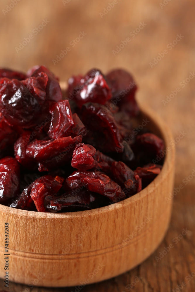 dried cranberries in a wooden cup on the table dried cranberries in a wooden cup on the table