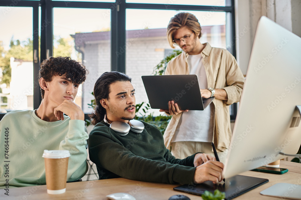 post-production team focused on a retouching project in office, man with laptop near coworkers post-production team focused on a retouching project in office, man with laptop near coworkers