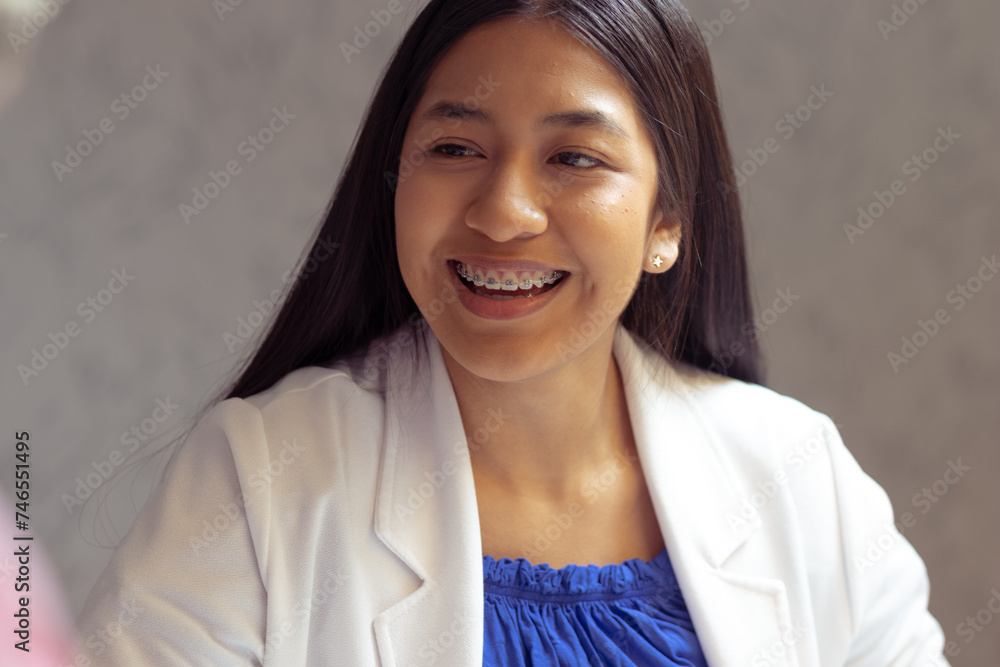 Woman with native features smiling. Formal outfit. Office, employment, study concept Woman with native features smiling. Formal outfit. Office, employment, study concept