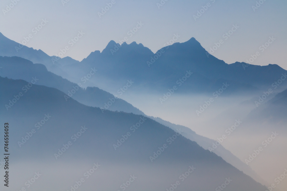 Spectacular mountain ranges silhouettes in shade of grey.