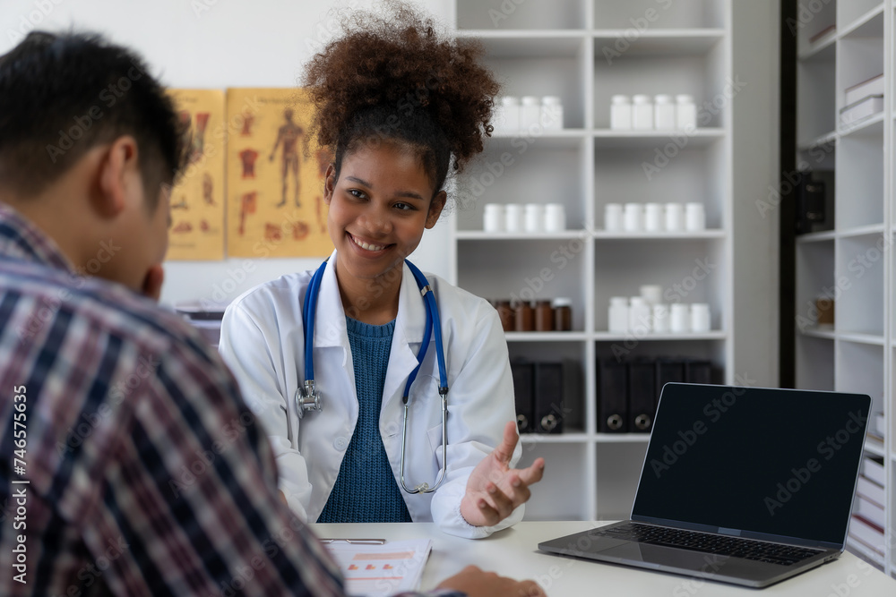 Female doctor examines her patient's arm while asking questions about his pain tolerance at the clinic for professional medical consultation. Happy man talks with doctor about his future treatment. Female doctor examines her patient's arm while asking questions about his pain tolerance at the clinic for professional medical consultation. Happy man talks with doctor about his future treatment.