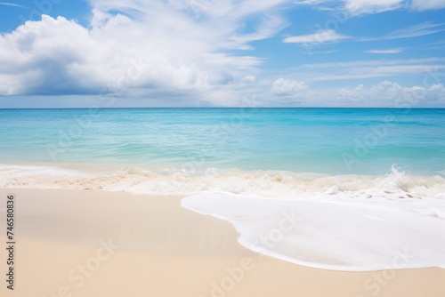 a beach with blue water and clouds