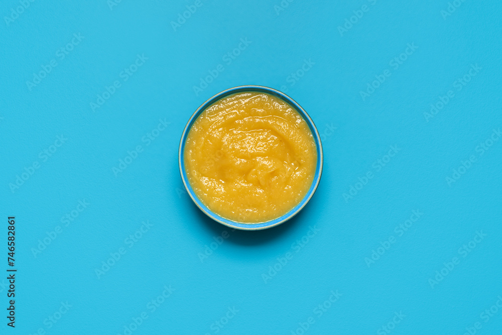 Apple sauce bowl above view, isolated on a blue background Apple sauce bowl above view, isolated on a blue background
