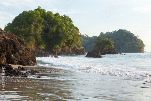 Pacific ocean beach with rocky islands covered in tropical vegetation, Manuel Antonio, Costa Rica photo