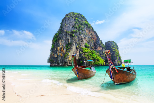 Thai traditional wooden longtail boat and beautiful sand Ao Phra Nang Beach in Krabi province.