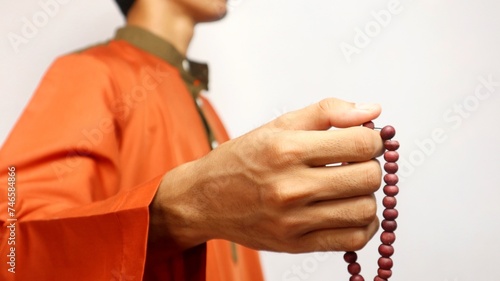 Asian Muslim man is holding prayer beads