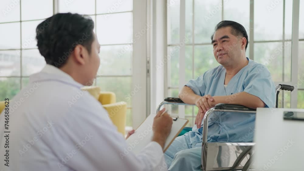 Asian elderly male patient talking with doctor while sitting on wheelchair in hospital. Asian elderly male patient consulting with doctor for treatment. Elderly healthcare, and medical concept Asian elderly male patient talking with doctor while sitting on wheelchair in hospital. Asian elderly male patient consulting with doctor for treatment. Elderly healthcare, and medical concept