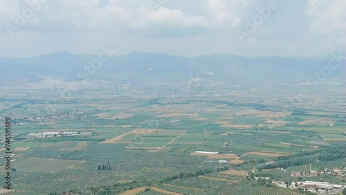 Dolly zoom. Lamia, Phthiotis, Greece. Panorama of the valley with fields. Olive trees, colorful fields. Summer, Cloudy weather, Aerial View photo