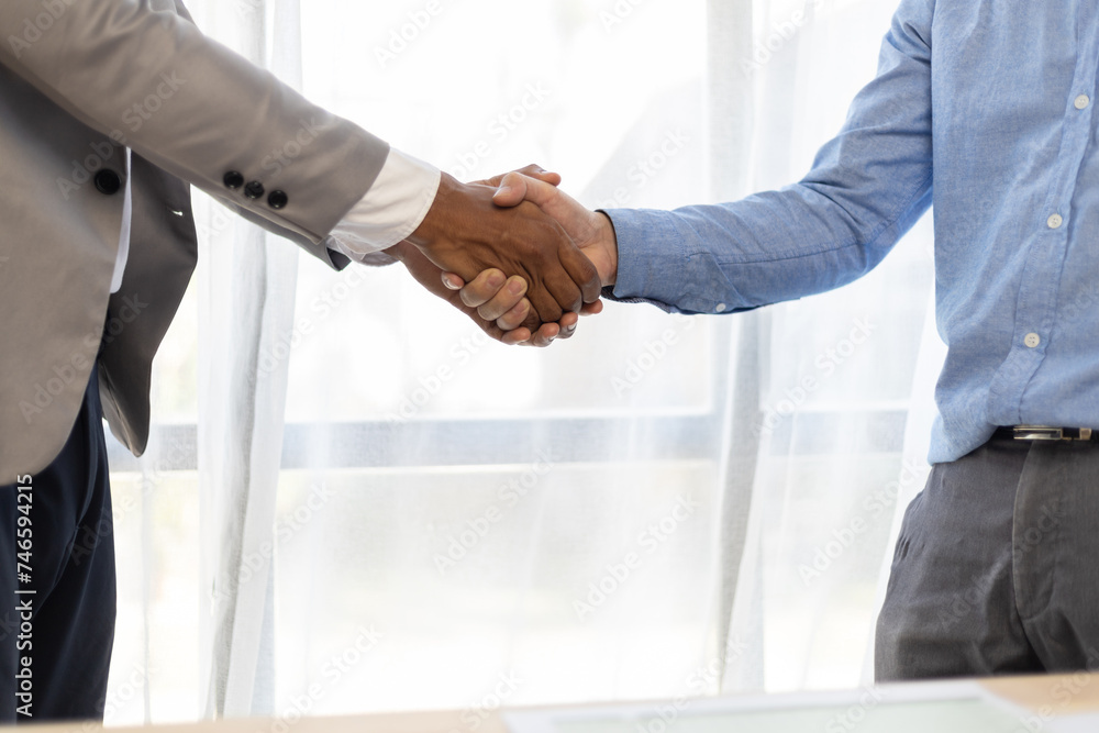 Meeting of business partners shaking hands in the office. Meeting of business partners shaking hands in the office.