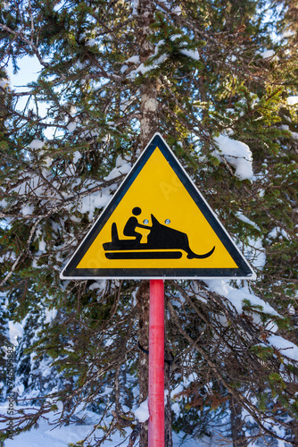 danger sign indicating the presence of a snowmobile on the trail