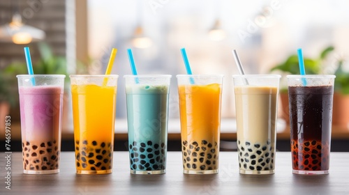 Colorful bubble tea glasses on bright table in trendy modern cafe, creating vibrant display.