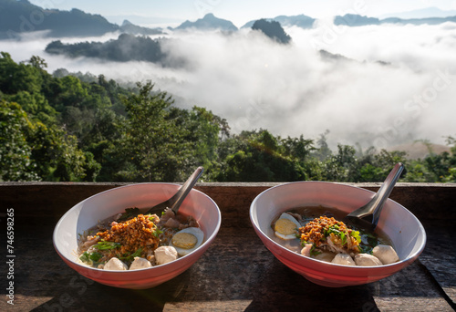 Noodles in a cup with a view of the sea of mist at Jabo village, Mae Hong Son, Thailand