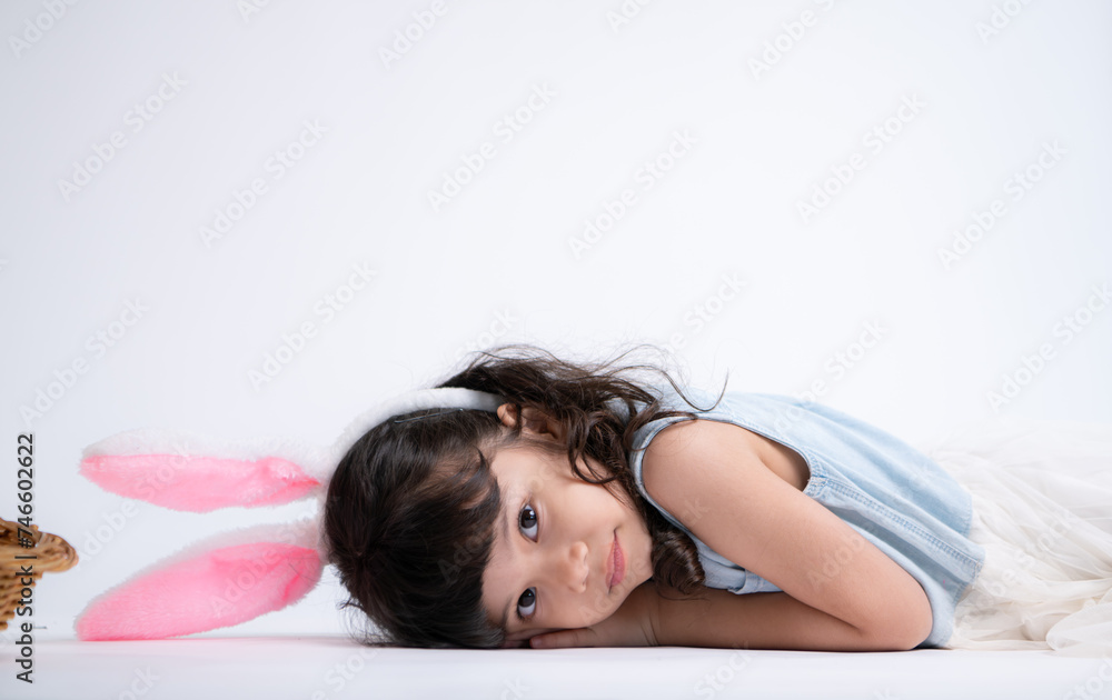 Fototapeta premium Smiling little girl and with their beloved fluffy rabbit, showcasing the beauty of friendship between humans and animals