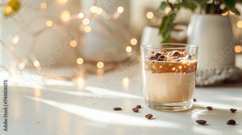 Cocoa on alternative milk with date paste and bran in glass on white table with ingredients. Delicious natural cocoa drink with grated chocolate and milk in glass. Side view, copy space. Recipe, menu