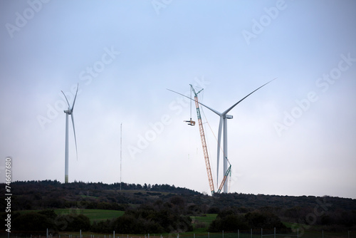Bild auf Leinwand Wind turbine being repaired, assisted by crane and elevator