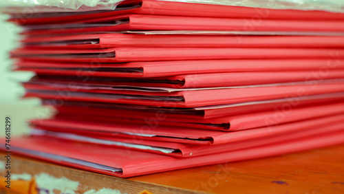 stack of red folders on the table