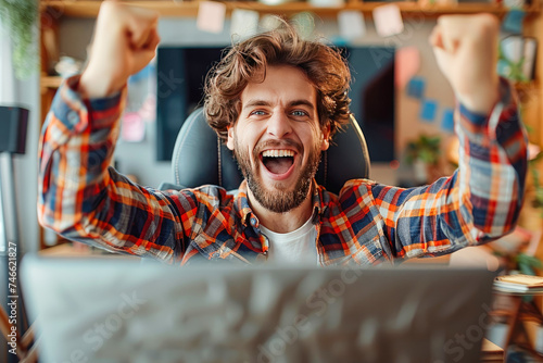 Excited happy man sitting in front of laptop, feeling like a winner, rejoicing at online victory, getting new job opportunity. Work from home, freelance photo