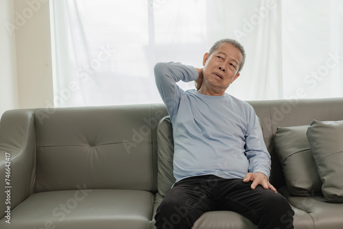 Asian elderly man has back pain and sickness in bed at home, unhappy elderly man touching his back seriously and trying, elderly care concept © ArLawKa