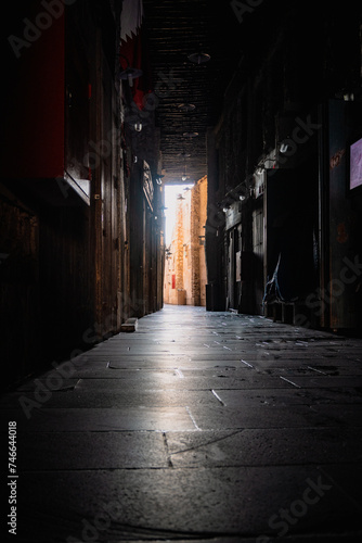 Doha, Qatar - February 8, 2024: A corridor through which sunlight enters during the day inside Souq Waqif inside Doha, Qatar © Mohamed