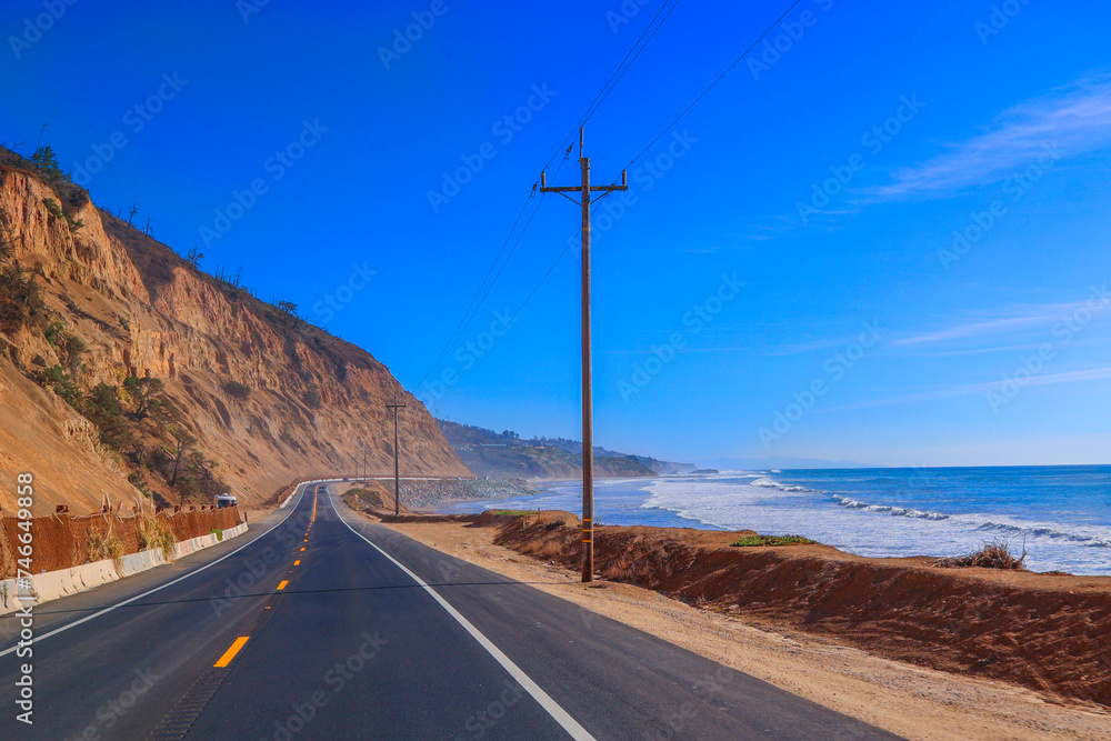 It's a scenic route, perfect for a relaxing road trip that offers stunning views of the ocean. It captures the calming essence of a leisurely drive along the coast. Coastal Road Car Journey. 