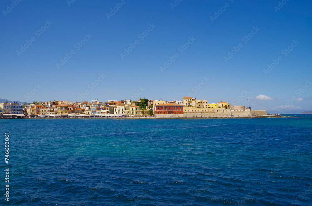 Picturesque cityscape skyline view of Chania, Crete with yacht marina, sailing boats, historic building facades, streets and urban living coast fisher atmosphere tourist destination Greek Islands