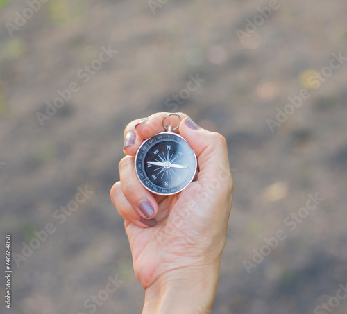 Person's hand holding a compass