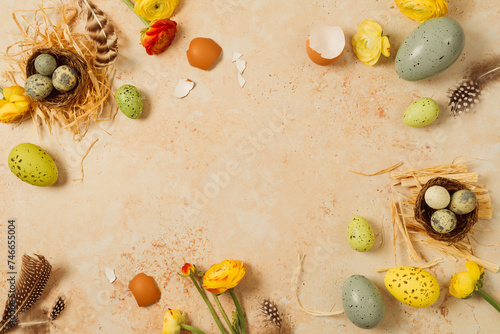 Easter holiday border frame background with easter eggs and spring flowers. Top view, flat lay