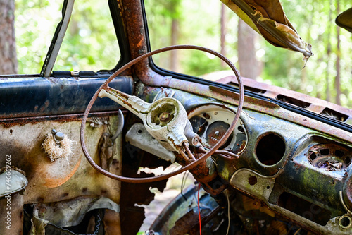 Interieur of Old cars in wild nature on the Kyrko Mosse Car Cemetery, former junkyard, in the forest, Kyrkö Mosse, Ryd, Smaland, Sweden photo