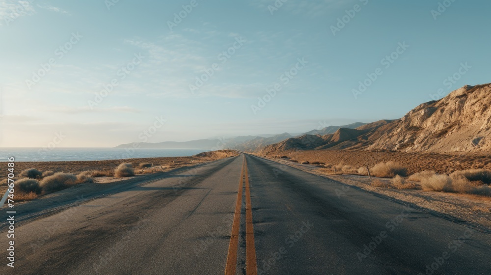 A deserted road stretching through the vast desert. Ideal for travel and adventure concepts.