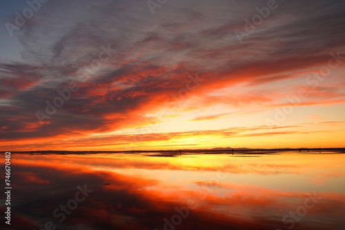 Colorful sunrise at Bonneville Salt Flats with spectacular water reflection near Wendover in Utah, United States photo