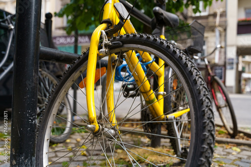 Yellow Bicycle Parked Next to Black Pole