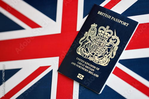 Blue British passport on national flag background close up. Tourism and citizenship concept