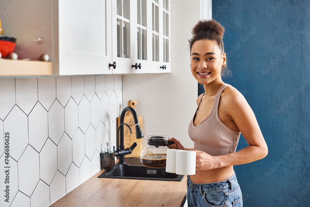 cheerful appealing african american woman in homewear holding coffee and smiling at camera cheerful appealing african american woman in homewear holding coffee and smiling at camera