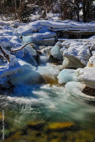Mountain river in a winter time with frozen ice