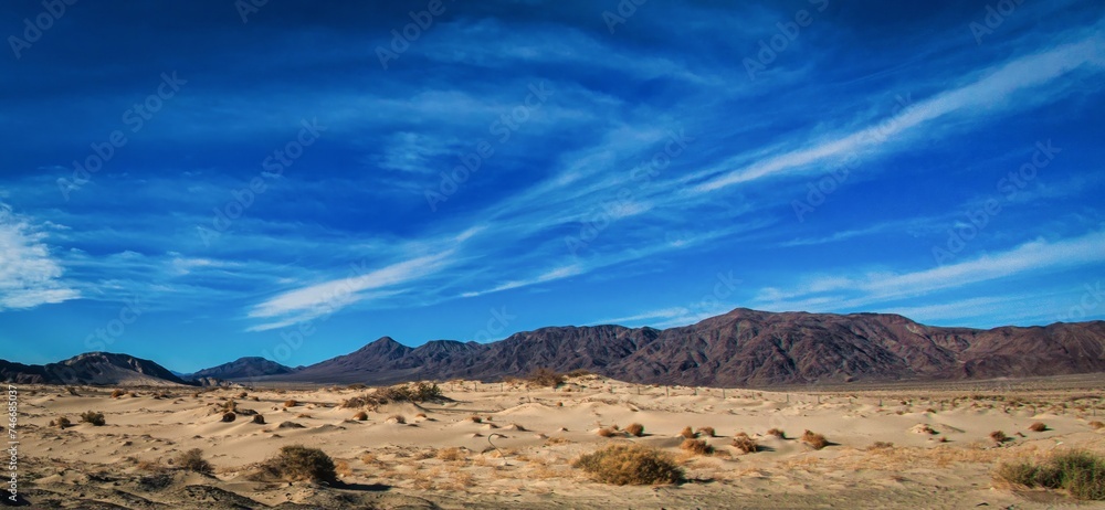 Las Vegas, United States - February 24 , 2013 : The dry desert countryside next to the road during the day between las vegas and los angeles Las Vegas, United States - February 24 , 2013 : The dry desert countryside next to the road during the day between las vegas and los angeles