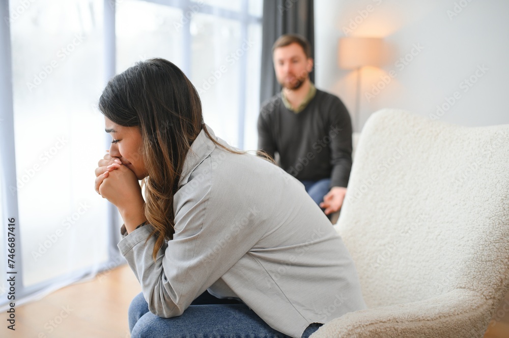 An agitated and upset husband shouts and looks at his wife, a quarrel between spouses. Family misunderstanding, quarrel An agitated and upset husband shouts and looks at his wife, a quarrel between spouses. Family misunderstanding, quarrel