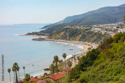 Santa monica mountiains meeting the ocean. Looking south down the Pacific Coast Highway towards Malibu on a hazy day.