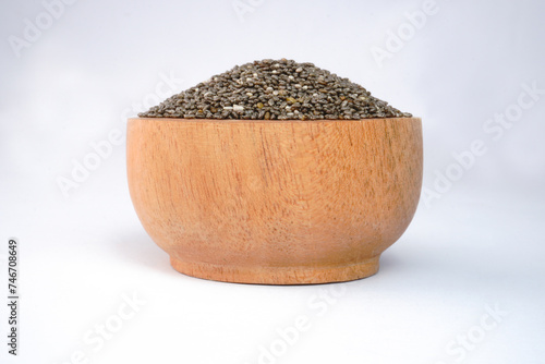 Chia seeds on a wooden bowl concept background © panadesignteam