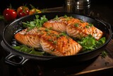 Salmon fillet with lemon and greens in a pan