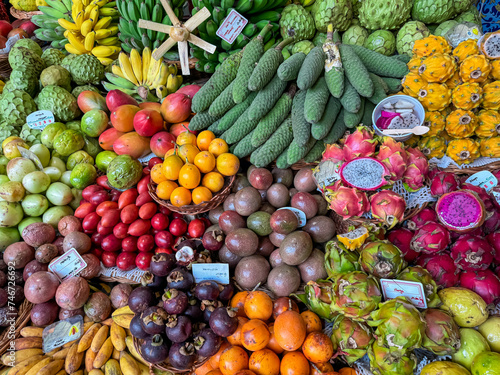 Exotic tropical fruit stall at Mercado dos Lavradores, Funchal, Madeira island, Portugal, Europe. Display of local healthy specialities on farmer market. Travel destination for food lovers. Tourism photo