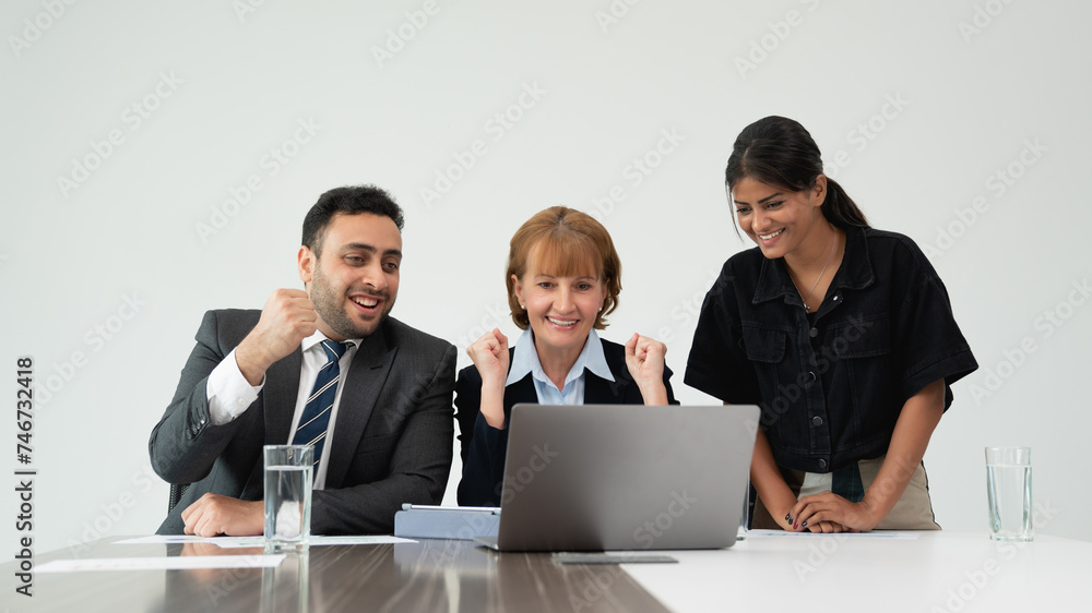 Three joyful business professionals tossing papers in the air in a bright office setting, celebrating success. Three joyful business professionals tossing papers in the air in a bright office setting, celebrating success.