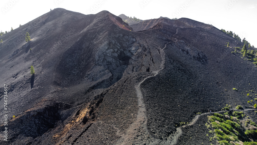aerial drone view of the crater of a volcano and the road that leads to the top aerial drone view of the crater of a volcano and the road that leads to the top