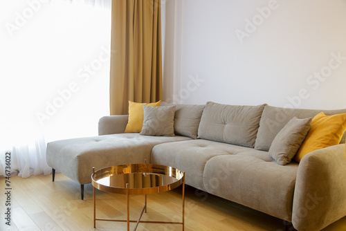 Modern cozy apartment with a touch of yellow, living room with sofa and dining table,	