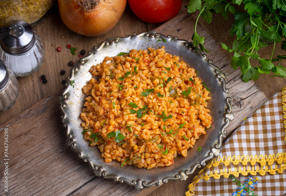 Traditional turkish bulgur pilaf with tomato sause in plate (Turkish name; meyhane pilavi) Traditional turkish bulgur pilaf with tomato sause in plate (Turkish name; meyhane pilavi)