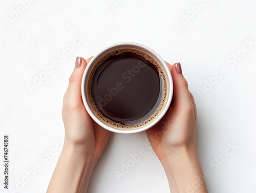 White mug of black coffee. Top view of a female hands in holding mug of delicious coffee. 