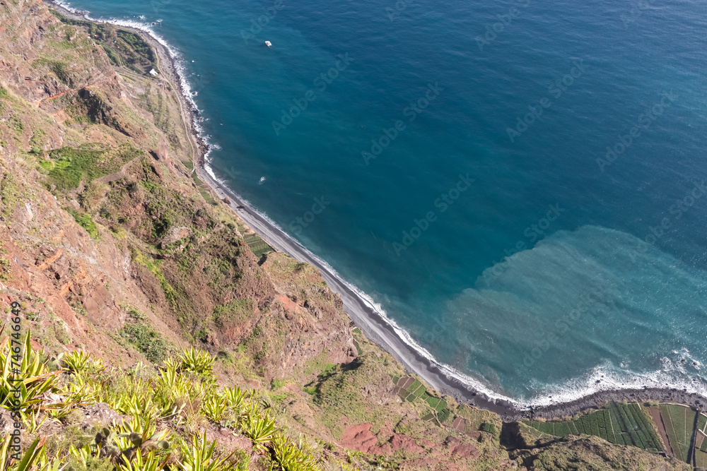 Spectacular aerial view of majestic coastline of Atlantic Ocean seen from viewing platform Cabo Girao Skywalk, Funchal, Madeira island, Portugal, Europe. Standing above steep cliff. Travel destination