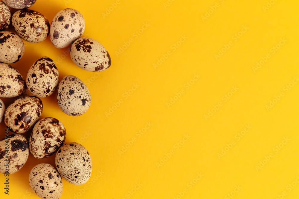 Quail eggs lays on yellow paper background with copy space or empty place for text. Easter holiday. Visiting card. Religious layout. Springtime design. Healthy food product. Farm organic production